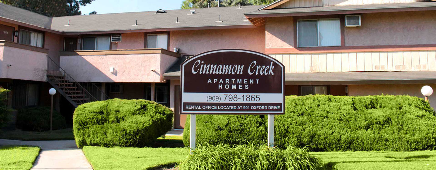 This image shows the signage of the Cinnamon Creek apartments